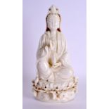 AN EARLY 20TH CENTURY CHINESE BLANC DE CHINE FIGURE OF GUANYIN modelled holding a Buddhistic