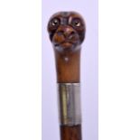 A CHARMING EARLY 19TH CENTURY FRUITWOOD DOG HEAD WALKING with glass eyes. 78 cm long.