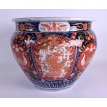 A MID 19TH CENTURY CHINESE JAPANESE MEIJI PERIOD IMARI JARDINIERE painted with foliage and vines. 25