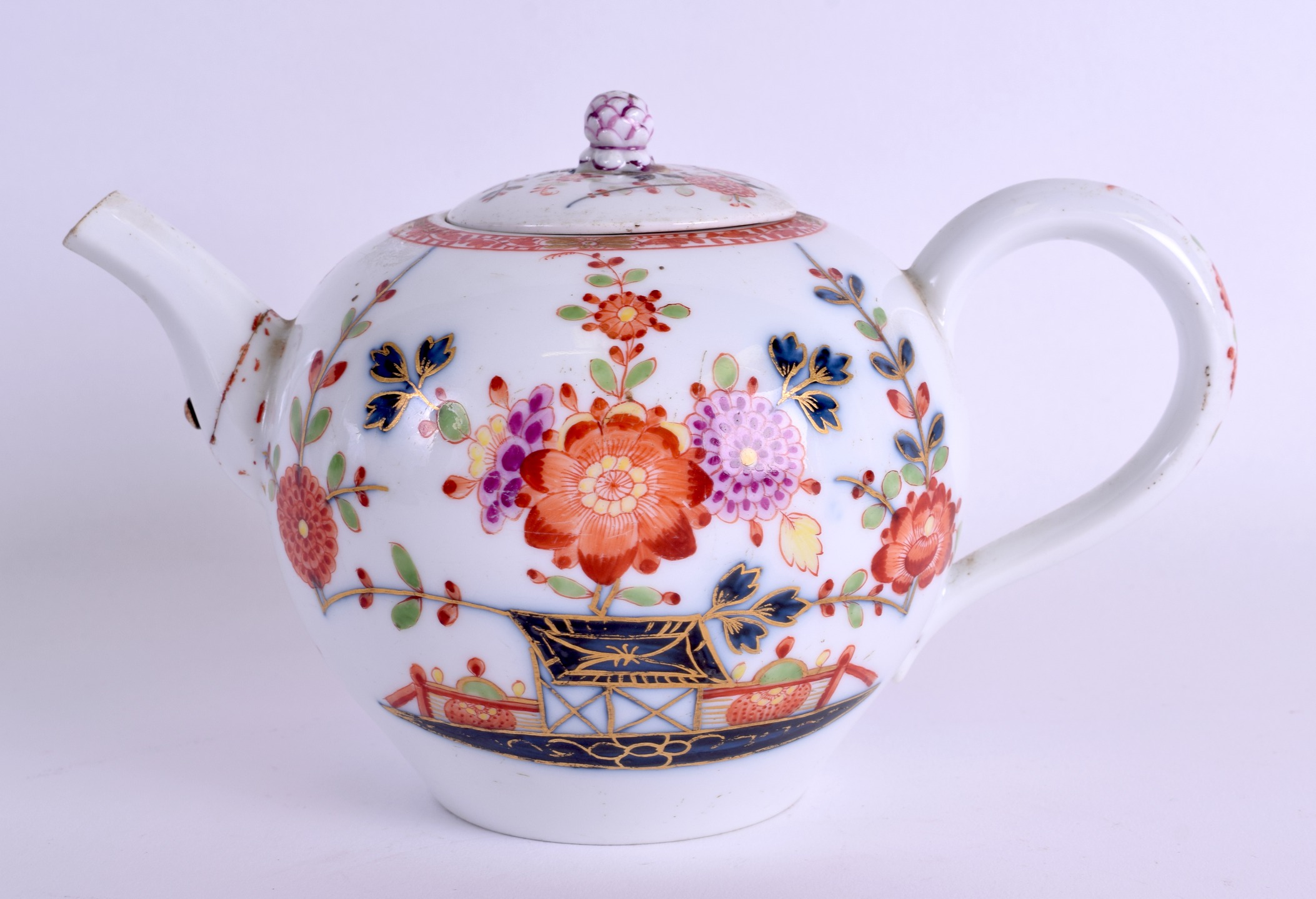 AN 18TH CENTURY MEISSEN PORCELAIN TEAPOT AND COVER painted with trees and foliage. 18 cm wide.