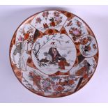 A LARGE 19TH CENTURY JAPANESE MEIJI PERIOD KUTANI PORCELAIN DISH painted with figures within