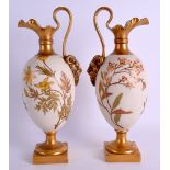 A PAIR OF EARLY 20TH CENTURY ROYAL WORCESTER BLUSH IVORY EWERS C1906, painted with flowers and