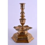 A 17TH CENTURY CONTINENTAL ENGRAVED BRONZE CANDLESTICK decorated with swirling motifs and mask