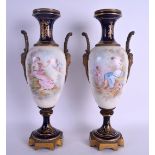 A LARGE PAIR OF 19TH CENTURY FRENCH SEVRES PORCELAIN TWIN HANDLED VASES painted with figures and