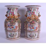 A LARGE PAIR OF 19TH CENTURY CHINESE CANTON FAMILLE ROSE VASES Qing, painted with figures and birds.