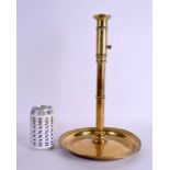 AN 18TH CENTURY CONTINENTAL ADJUSTABLE BRASS CANDLESTICK with large circular pan. 37 cm high.