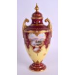 AN EARLY 20TH CENTURY COALPORT VASE AND COVER painted with a landscape on an unusual crimson ground.