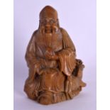 A 19TH CENTURY CHINESE CARVED SOAPSTONE FIGURE OF SAGE modelled holding a fruiting pod beside a