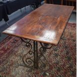 A MAHOGANY DINING TABLE WITH WROUGHT IRON BASE, reputedly metal from the gates of London