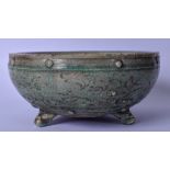 A CHINESE GREEN GLAZED POTTERY TRI LEGGED CENSER, incised with foliage and beaded banding to rim.