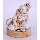 AN UNUSUAL 19TH CENTURY STONEWARE BLANC DE CHINE FIGURE OF A MALE imitating ivory upon a circular