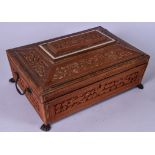 A LARGE 19TH CENTURY ANGLO INDIAN SANDALWOOD CASKET, carved with extensive foliage on four paw feet.