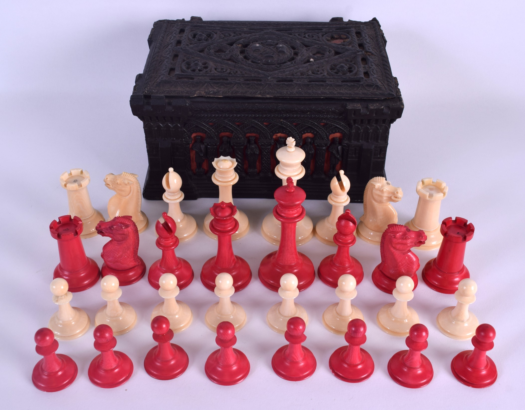 A GOOD 19TH CENTURY JACQUES STAUNTON IVORY CHESS SET within a Carton-Pierre casket, decorated with