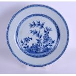 AN EARLY 18TH CENTURY CHINESE BLUE AND WHITE PORCELAIN PLATE Qianlong, painted with a fenced garden.
