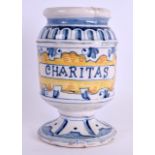 A 19TH CENTURY EUROPEAN FAIENCE MAJOLICA DRUG JAR entitled Charitas. 14.5 cm high.