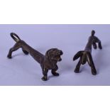 AN UNSUAL PAIR OF ELONGATED BRONZE SAUSUAGE DOG FIGURES, possibly knife rests. 8 cm wide.