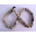 A 19TH CENTURY CHINESE CARVED MUTTON JADE BEAD NECKLACE formed with uniform beads. 74 cm long.