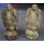 A LARGE PAIR OF CONCRETE EAGLES, formed seated upon a rock. 45 cm high.