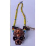 AN EARLY 20TH CENTURY BURMESE NAGA NECLKACE, formed with assorted beads and monkey skull. skull 11