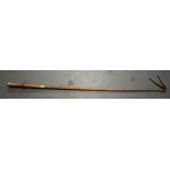 AN EARLY 20TH CENTURY RIDING CROP, white metal handle "Scottish, Norse, South Africa". 84 cm long.