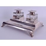 AN EDWARDIAN SILVER DOUBLE INKWELL DESK STAND presented to Mark H Drury. London 1911. 20 oz. 22 cm x