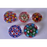 A GROUP OF FIVE MILLIFIORI GLASS PAPERWEIGHTS, of varying design. Largest 5 cm x 5.5 cm.