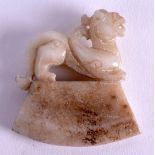 A CHINESE CARVED MING STYLE JADE AMULET 20th Century, modelled with a a buddhistic beast terminal. 5