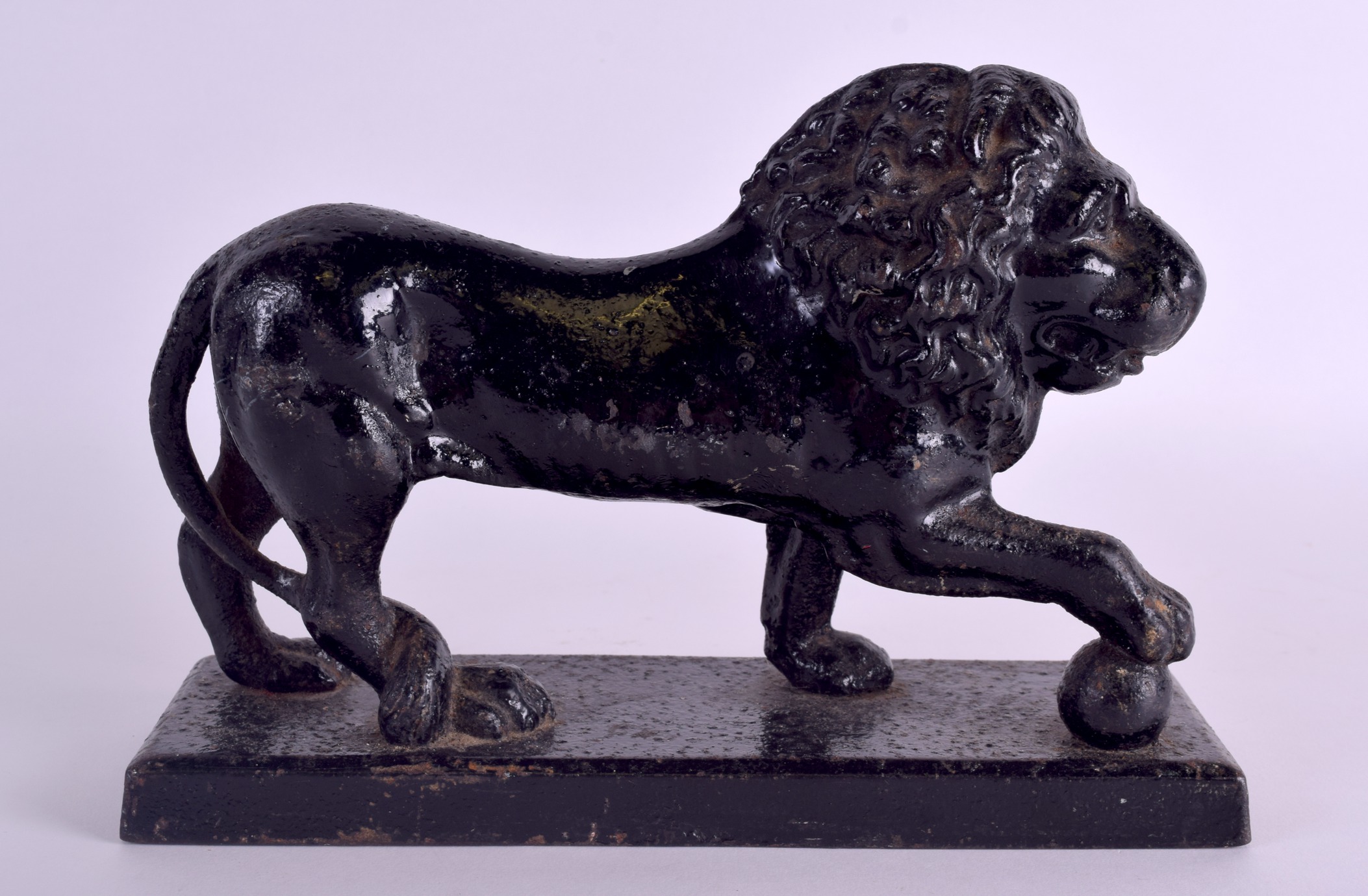 A GEORGE III PAINTED CAST IRON LION DOOR STOP. 24 cm x 8 cm.