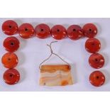 A CARVED AGATE PENDANT, together with a quantity of red hardstone beads. Pendant 2.8 cm.