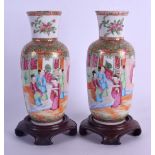 A PAIR OF 19TH CENTURY CHINESE CANTON FAMILLE ROSE PORCELAIN VASES painted with birds and foliage.