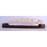 A 19TH CENTURY JAPANESE MEIJI PERIOD CARVED IVORY OKIMONO modelled a group of roaming elephants.