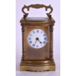 AN EARLY 20TH CENTURY FRENCH BRASS AND ENAMEL CARRIAGE CLOCK with circular dial and blue numerals.