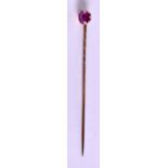 AN EDWARDIAN 9CT ROSE GOLD AND RUBY TIE PIN. 6.5 cm long.