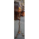 AN EARLY 20TH CENTURY OIL LAMP, formed with twisted metal supports. 166 cm high.