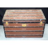A GOOD ANTIQUE FRENCH LOUIS VUITTON TRAVELLING TRUNK with iron mounts and red painted wooden body.