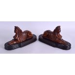 A PAIR OF 18TH CENTURY CONTINENTAL CARVED WOOD SPHINXES modelled upon later ebonised wooden plinths.