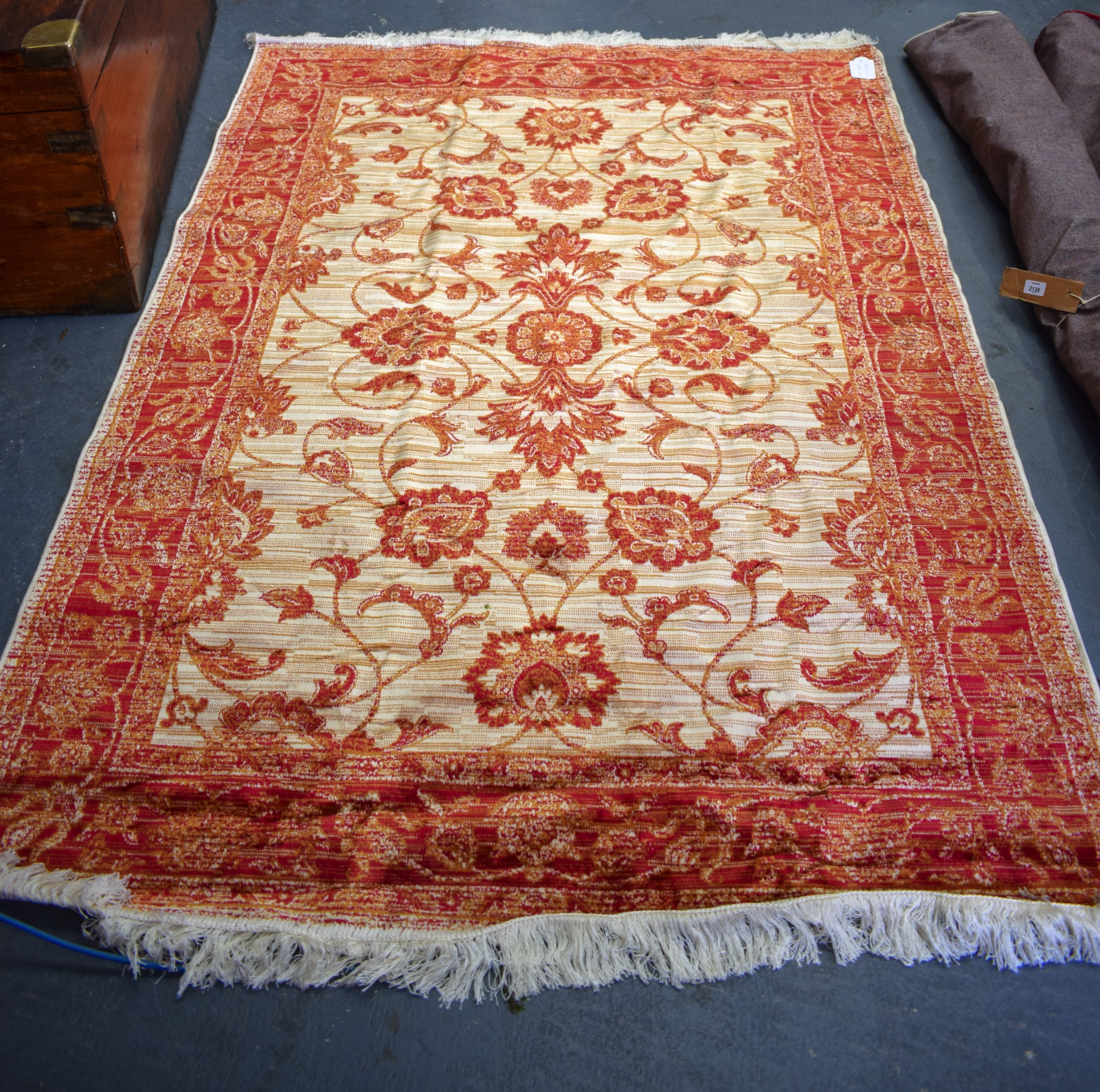 A 20TH CENTURY RED GROUND ZIEGLER RUG, decorated with foliage. 190 cm x 140 cm.