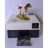 A ROYAL DOULTON PORCELAIN FIGURINE OF A DOG, contained within a fitted box. Figure 21 cm wide.
