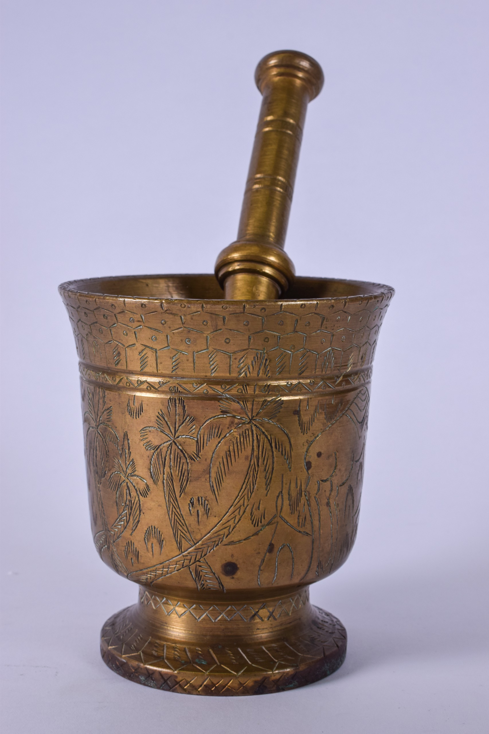 AN EARLY 20TH CENTURY HEAVY BRONZE PESTLE AND MORTAR, engraved with Eastern scenes depicting a camel - Image 2 of 4