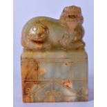 A CHINESE JADE SEAL, decorated with a mythical beast terminal and gold highlight inlay. 8 cm high.