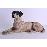 A GOOD LATE 19TH CENTURY AUSTRIAN COLD PAINTED TERRACOTTA HOUND modelled as a recumbent Jack