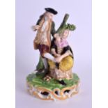 AN EARLY 19TH CENTURY DERBY FIGURAL GROUP modelled as a female polishing a males shoes. 15 cm high.