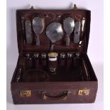 A GOOD 1920S LEATHER AND SILVER TOPPED TRAVELLING SET including numerous silver topped bottles,