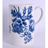 AN 18TH CENTURY WORCESTER MUG printed in underglaze blue with large flowers. 12 cm high.