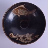 A CHINESE QING DYNASTY HARES FOOT TYPE POTTERY BOWL decorated with two opposing fish. 15.5 cm