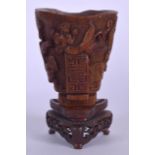 A CHINESE CARVED LIBATION CUP, decorated with mythical beasts and archaic symbolsm, together with