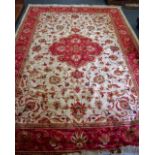 A LARGE RED GROUND KESHAN RUG, decorated with foliage. 280 cm x 200 cm.