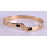 AN ANTIQUE 9CT GOLD AND DUAL STONE BANGLE. 18.8 grams. 7 cm wide.