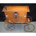 AN EARLY 20TH CENTURY EUROPEAN CARVED WOOD GYPSY WAGON with several additions and hanging pots &