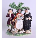 AN 18TH CENTURY DERBY TITHE PIG GROUP modelled as a farmer with his wife and another person. 16